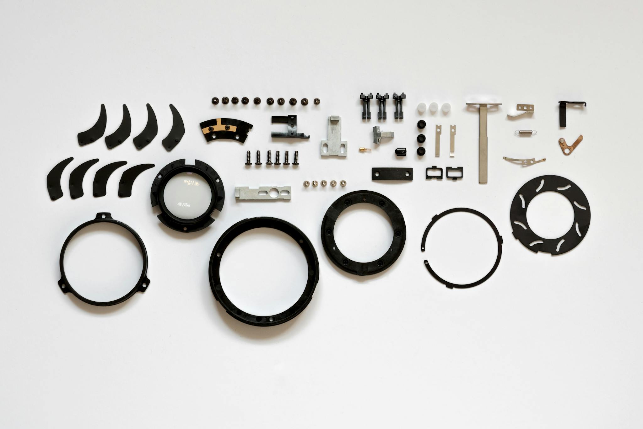 Organized layout of mechanical parts on a white surface, ideal for tech and engineering themes.
