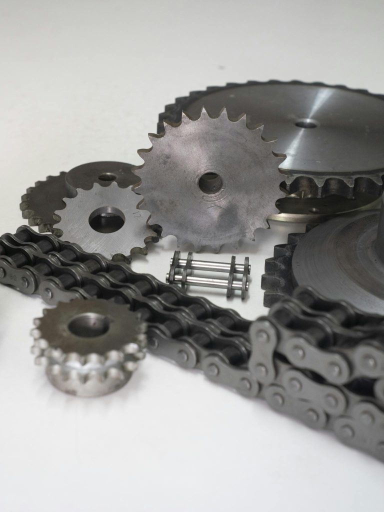 Close-up of metal gears and chains showcasing industrial engineering parts.
