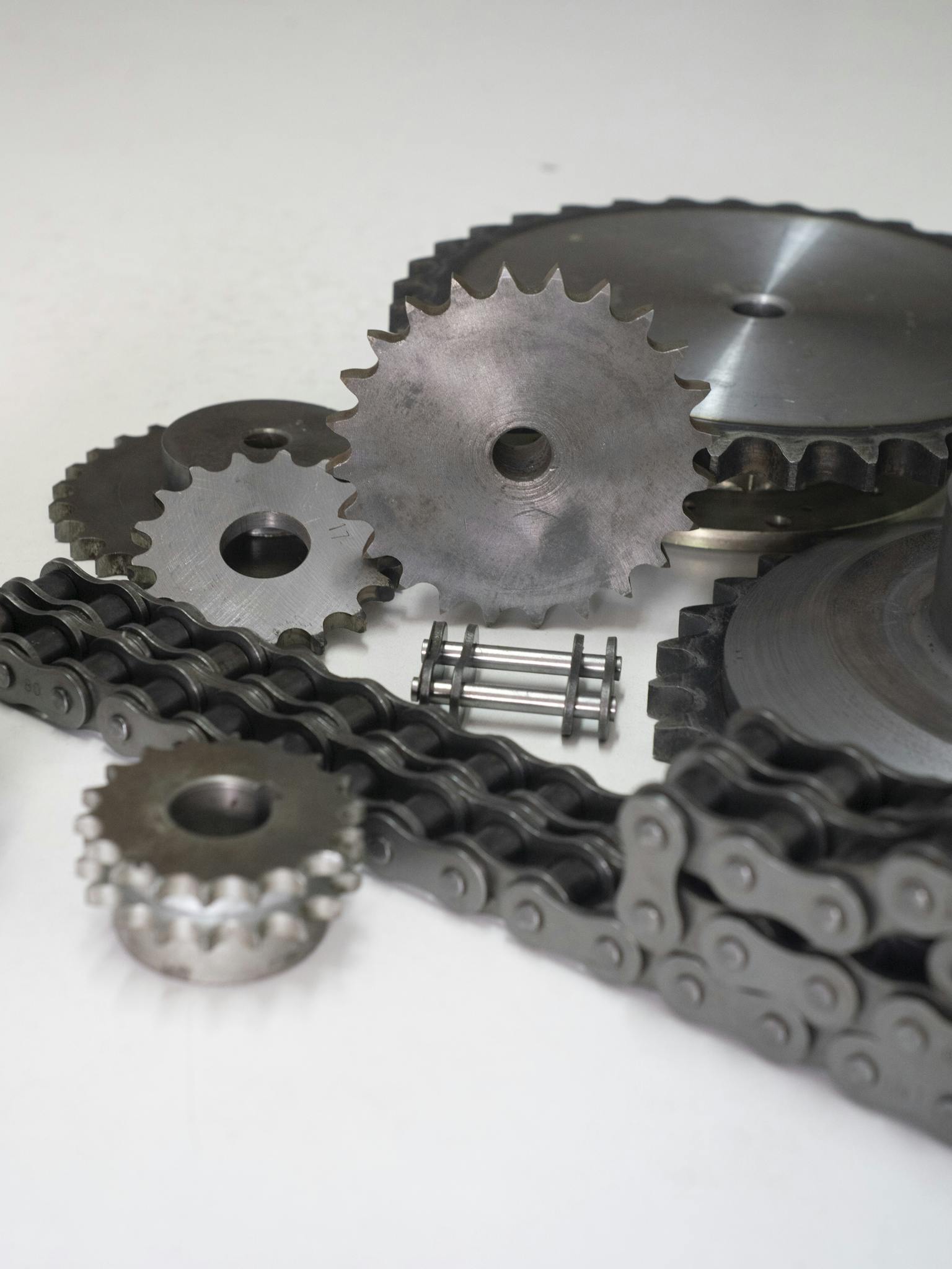 Close-up of metal gears and chains showcasing industrial engineering parts.